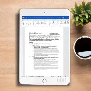 May include: A white tablet displays a document with text, likely a legal document, with headings like "Case Information" and "Key Facts." A small green plant and a cup of coffee sit nearby.
