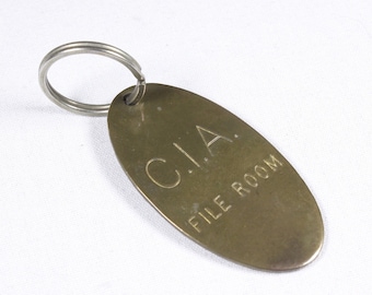 Vintage brass CIA File room key fob, 1976 Lowell Sigmund key ring, rare collectible joke key holder ring