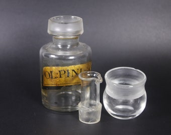 Antique apothecary bottle with cup lid ol pini sylv, rheumatism cure medicine bottle