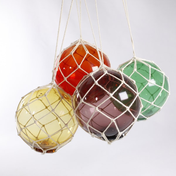 Vintage Japanese glass fishing floats, colourful glass buoy balls in twine netting, suncatcher window decor