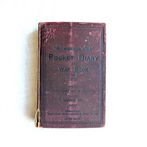 May include: A burgundy-colored book titled "The Mechanical World" Pocket Diary and Year Book for 1911. The book is the twenty-fourth year of publication and costs sixpence.