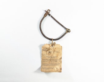 Candado para bolsa de equipo de un teniente del ejército canadiense de la Segunda Guerra Mundial + etiqueta de identificación de equipaje del distrito militar