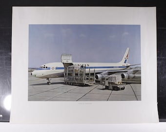 May include: A vintage photograph of a United Airlines DC-8 Jet Freighter on the tarmac. The aircraft is white with blue stripes and the United logo. Ground crew and cargo are visible.