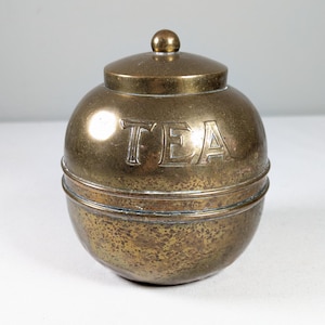 Antique 1920s brass tea caddy, British Empire ball shaped lidded kitchen canister, tea leaf storage jar