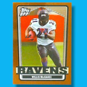 May include: A Topps OPP football trading card featuring Willis McGahee of the Baltimore Ravens. The card has a gold border and displays McGahee in action, wearing a white jersey with the number 21. The Ravens logo is prominently displayed.