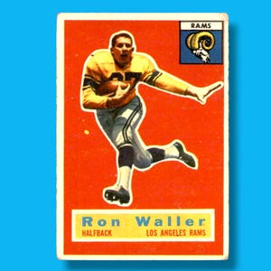 May include: Vintage football trading card featuring Ron Waller of the Los Angeles Rams. The card has a red background with a player in a yellow and white uniform. The Rams logo is in the upper right corner. The player is in action, holding a football.