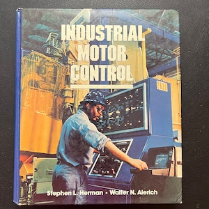 May include: A blue book with the title "Industrial Motor Control" and the author names "Stephen L. Herman - Walter N. Alerich". The cover features a photo of a person wearing a hard hat and operating a control panel.
