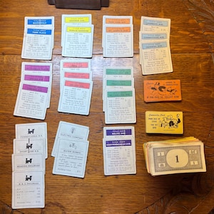 Monopoly Game Pieces  - Money, Property Cards, Chance and Community Chest Cards. (Dated 1961)
