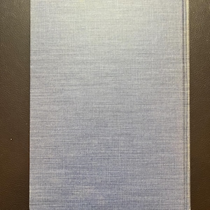 May include: A blue book with a textured linen cover.