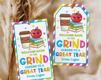 May include: Two rectangular gift tags with brown ribbon loops, featuring a colorful border and illustrations of a coffee cup, a stack of books, and a red apple with a face. The text reads: Welcome back to the grind, cheers to a great year, from, Logan.