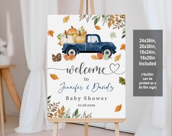 May include: A welcome sign for a baby shower featuring a blue pickup truck carrying pumpkins and autumn leaves. The sign reads "Welcome to Jennifer & David's Baby Shower 10.28.20XX". The sign is available in 24x36in, 20x30in, 18x24in, and 16x20in sizes.