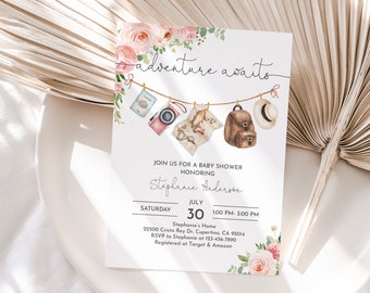 May include: A baby shower invitation with a watercolor illustration of a passport, camera, map, backpack, and hat hanging on a clothesline. The text reads "adventure awaits" and includes the details of the event: "Join us for a baby shower honoring Stephanie Anderson, Saturday, July 30, 1:00 PM - 3:00 PM, Stephanie's Home, 22500 Cristo Rey Dr., Cupertino, CA 95014, RSVP to Stephanie at 123-456-7890, Registered at Target & Amazon."