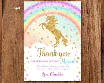 May include: A thank you card with a gold glitter unicorn and a rainbow with stars. The text reads "Thank you for making my birthday magical. I loved the cake and my presents too, but my favorite part was seeing you! Love, Charlotte."