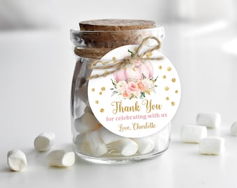 May include: A small glass jar filled with white marshmallows and a round thank you tag with a pink and gold pumpkin design. The tag reads "Thank You for celebrating with us Love, Charlotte".
