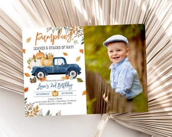 May include: An invitation for Logan's 2nd birthday. The design features a blue truck carrying pumpkins, with fall leaves and the text "Pumpkins, Leaves & Stacks of Hay!". A photo of a smiling child is on the right.