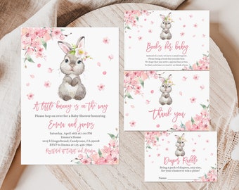 May include: A baby shower invitation with a pink and white floral design featuring a bunny rabbit. The invitation reads "A little bunny is on the way" and includes the names "Emma and James".