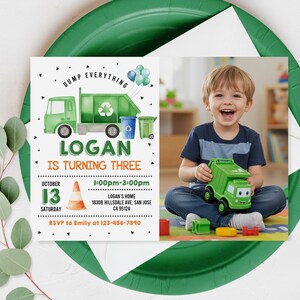 May include: A green and orange birthday invitation for a child turning three. The invitation features a cartoon garbage truck, a recycling bin, and a cone. The text on the invitation reads "Dump Everything Logan is Turning Three" and includes the date, time, and location of the party.