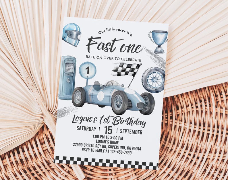 May include: A blue and white birthday invitation with a cartoon race car, checkered flag, and a gas pump. The text reads "Our little racer is a Fast one Race on over to celebrate Logan's 1st Birthday Saturday | 15 | September 1:00 PM to 3:00 PM Logan's Home 22500 Cristo Rey Dr, Cupertino, CA 95014 RSVP to Emily at 123-456-7890"