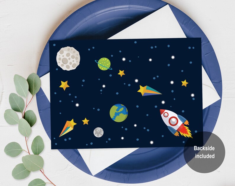 May include: A blue card with a space-themed design. The card features a rocket, planets, stars, and a crescent moon. The text "Backside Included" is printed on the bottom right corner of the card.