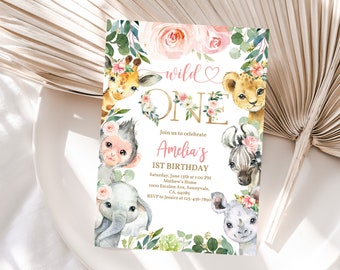 May include: A pink and gold first birthday invitation with a jungle theme. The invitation features a giraffe, monkey, elephant, zebra, and rhinoceros with floral accents. The text reads "Wild One" and "Amelia's 1st Birthday".