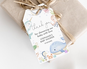 May include: A white thank you tag with a blue whale, a narwhal, a seahorse, a turtle, and an octopus. The tag says "Thank you for showering our baby with love Stephanie's Baby Shower 07.20.20XX".
