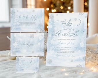 May include: A set of baby shower invitations and cards with a winter theme. The invitation reads "Baby it's cold outside" with event details. Additional cards say "books for baby", "thank you", and "diaper raffle".