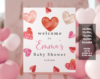 May include: Welcome to Emma's Baby Shower sign with a pink and red watercolor heart design. The sign is available in sizes 24x36 inches, 20x30 inches, 18x24 inches, and 16x20 inches. The 16x20 inch size can be printed as an 8x10 inch sign.