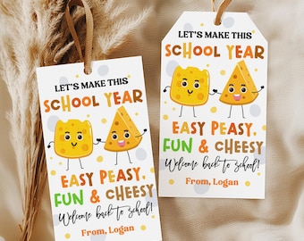 May include: Two rectangular white gift tags with brown ribbon loops. Each tag features cartoon cheese characters and the text: LET'S MAKE THIS SCHOOL YEAR EASY PEASY, FUN & CHEESY Welcome back to school! From, Logan. The design includes yellow and grey dots.