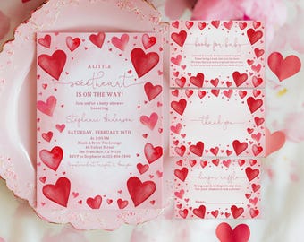 May include: Baby shower invitations and cards with a watercolor heart theme. The main invitation reads "A Little Sweetheart is on the Way!" with event details. Additional cards include "Books for Baby," "Thank You," and a diaper raffle.