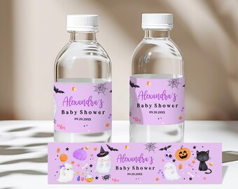 May include: Purple and black Halloween baby shower water bottle labels with a ghost, pumpkin, and bat design. The labels say "Alexandra's Baby Shower" and include the date "09.20.20XX".