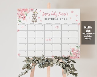 May include: A printable 16x20 inch sign with a pink floral design and a calendar for guessing a baby's birthday. The calendar is for June and July and has a pink bunny rabbit illustration with a floral crown. The text on the sign reads "Guess baby Emma's Birthday Date".