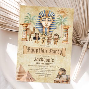 May include: An invitation for an Egyptian-themed party. The design features illustrations of an Egyptian pharaoh, a camel, palm trees, and cartoon figures. The text reads "Egyptian Party" and details for Jackson's 10th birthday.