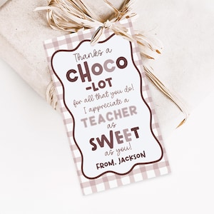 May include: A gift tag with a brown and white checkered pattern and a wavy border. The tag reads "Thanks a Choco-Lot for all that you do! I appreciate a TEACHER as SWEET as you! FROM. JACKSON."