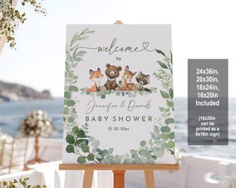 May include: Welcome to Jennifer & David's Baby Shower sign with a watercolor eucalyptus wreath and woodland animals including a fox, bear, and raccoon. The sign is available in 24x36in, 20x30in, 18x24in, and 16x20in. The 16x20in size can be printed as an 8x10in sign.