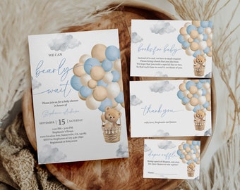 May include: A baby shower invitation with a blue and beige colour scheme. The invitation features a teddy bear in a hot air balloon with blue and beige balloons. The text on the invitation reads "We can barely wait" and "Please join us for a baby shower in honour of Stephanie Anderson".
