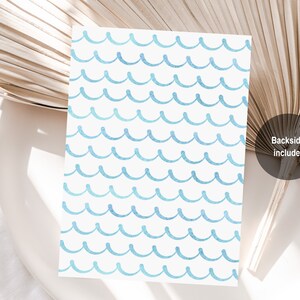 May include: A white card with a blue watercolor wave pattern. The back side of the card is included.