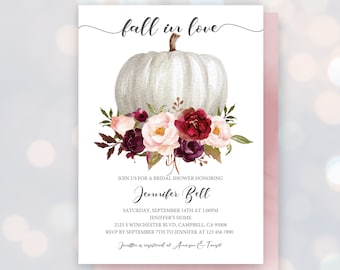 May include: Fall in love bridal shower invitation featuring a white pumpkin adorned with burgundy and pink flowers. The invitation includes the bride's name, date, time, and location. RSVP details are also provided.