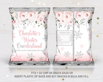 May include: Pink and silver chip bags with a floral design and snowflakes. The bags say "Charlotte's Winter Onederland" and "Thank you for celebrating with me!"