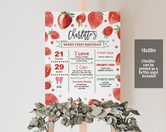 May include: A printable first birthday sign with a strawberry theme. The sign features a red and green border with a white background. It includes the child's name, "Charlotte's", and details about their first year, such as their weight, height, and favorite foods and songs. The sign is 16x20 inches and can be printed as an 8x10 inch sign.