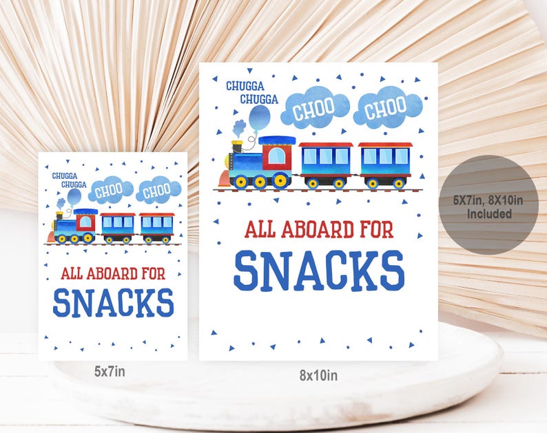 May include: Two printable signs featuring a cartoon train with the text "All Aboard for Snacks" in blue and red. The larger sign is 8x10 inches and the smaller sign is 5x7 inches.
