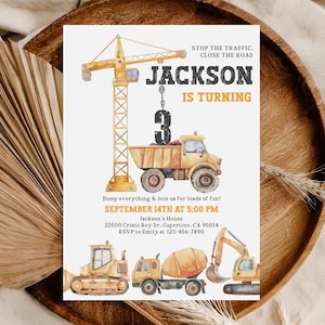 May include: A watercolor-style birthday invitation featuring construction vehicles and a crane. The invitation reads "Jackson is Turning 3" with the date and time of the party. The design includes a dump truck, cement mixer, and excavator.