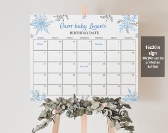 May include: A white calendar sign with blue floral accents and the text "Guess baby Logan's BIRTHDAY DATE." The calendar is displayed on a wooden easel and includes the text "16x20in sign (16x20in can be printed as 8x10in)."