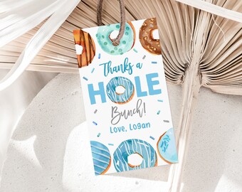 May include: A white gift tag with watercolor donuts in shades of brown, blue, and orange. The tag reads "Thanks a HOLE bunch!" in teal and "Love, Logan" in gray. A brown string is attached at the top.