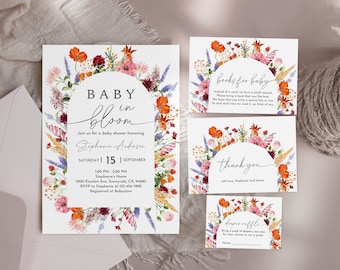 May include: A floral baby shower invitation with a watercolor wreath of flowers in shades of orange, pink, red, and purple. The text reads "Baby in Bloom" and includes the date, time, and location of the event. The invitation also includes a request for books for the baby, a thank you note, and a diaper raffle.