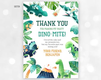 May include: A thank you card with a dinosaur theme. The card is white with green and blue watercolor illustrations of dinosaurs, plants, and a volcano. The text on the card reads "Thank You for making my party Dino-mite! I loved the cake and my presents too, but my favorite part was seeing you! Your friend, Benjamin."