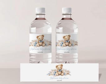 May include: Two clear plastic water bottles with labels featuring a watercolor illustration of a teddy bear wearing a blue bow tie. The labels also include the text "Stephanie's Baby Shower" and a date. A smaller label with the same design is shown below the bottles.