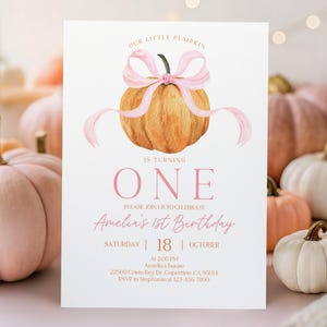 May include: A birthday invitation featuring a watercolor pumpkin with a pink bow. The text reads "Our Little Pumpkin is Turning One" and includes party details. The background includes several pumpkins in shades of pink and white.