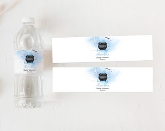 May include: Water bottle label with a blue and white watercolor background. The label features a black cauldron with a blue banner that says "Brewing Alexandria's Baby Shower 09.20.23". There are bats and stars in the background.