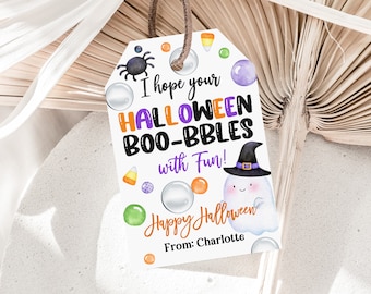 May include: A white tag with a purple, orange, and green Halloween theme. It says "I hope your HALLOWEEN BOO-BBLES with Fun!" and "Happy Halloween" with a cute ghost illustration. The tag is signed "From: Charlotte".