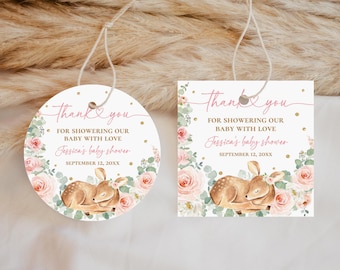May include: Baby shower thank you tags, round and square, with a sleeping fawn illustration. The tags feature floral accents, the text "Thank you", and the baby shower details. The tags are tied with string.